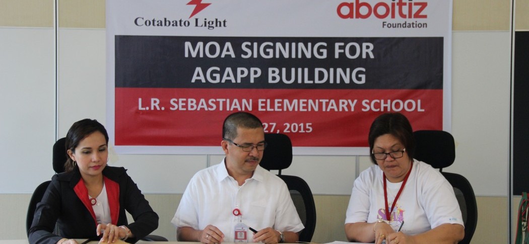 AGAPP IN COTABATO. Cotabato Light HR and Community Relations Staff Michelle Prudente, Cotabato Light Assistant Vice President and Resident Manager Engr. Judy Sanchez, and Principal Josephine Alim of L.R. Sebastian Elementary School during the signing of the Memorandum of Agreement governing the donation of a one-storey, 2-classroom AGAPP kindergarten school building.