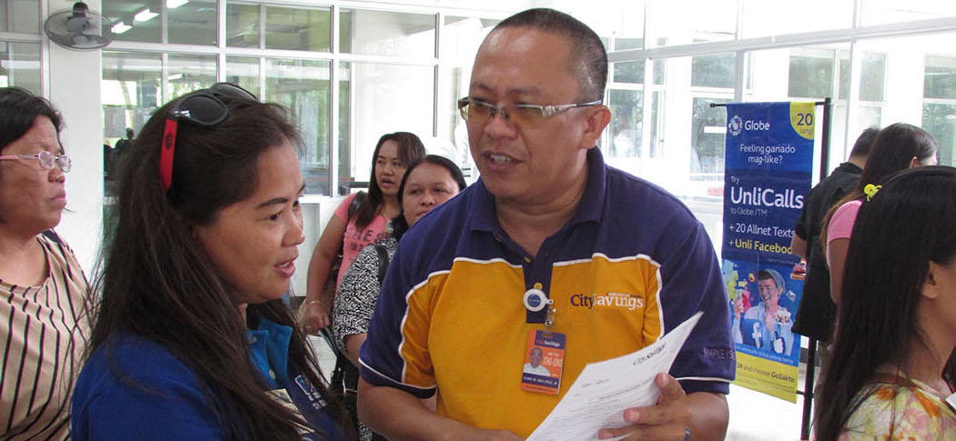 PREPARATION FOR K-12. CitySavings Colon branch marketing associate Claro dela Cruz entertains a loan query from a public school teacher.