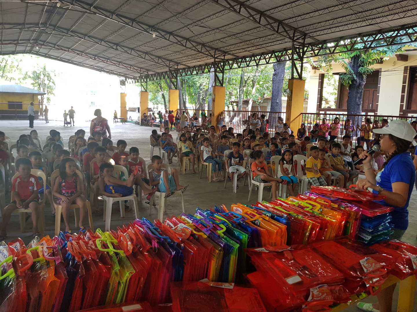 Kay Ingan of VECO Kaibigans Batch 18 gives a speech before she and her fellow teammates distribute school supplies to 100 deserving Grade 1 pupils of Cebu City.